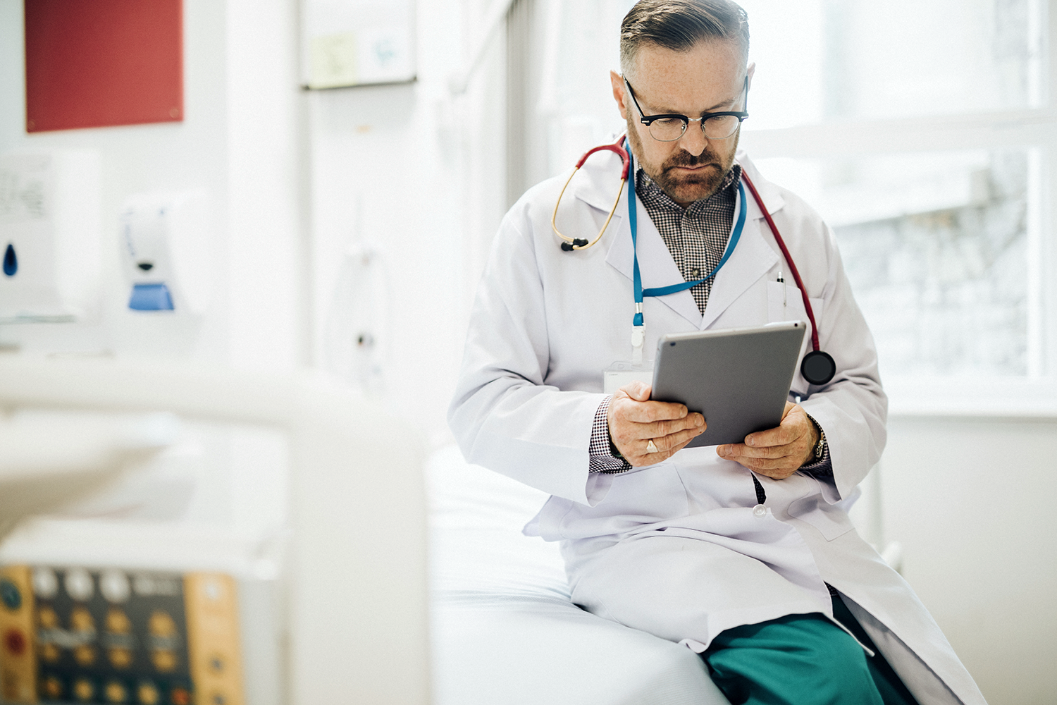physician.reading.health.news.on.tablet.png
