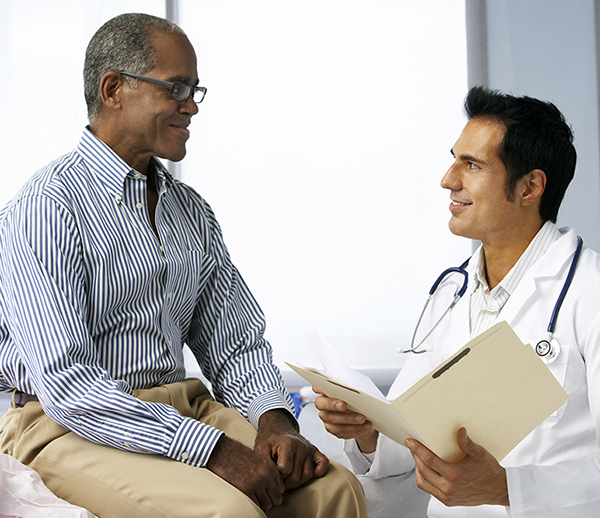 Doctor In Surgery With Male Patient Reading Notes - for web.jpg
